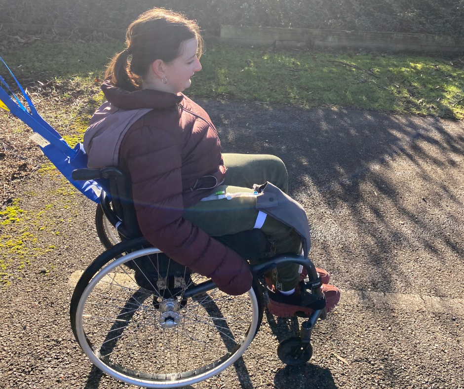 Ester is sat in her wheelchair practicing her wheelchair training outside the centre