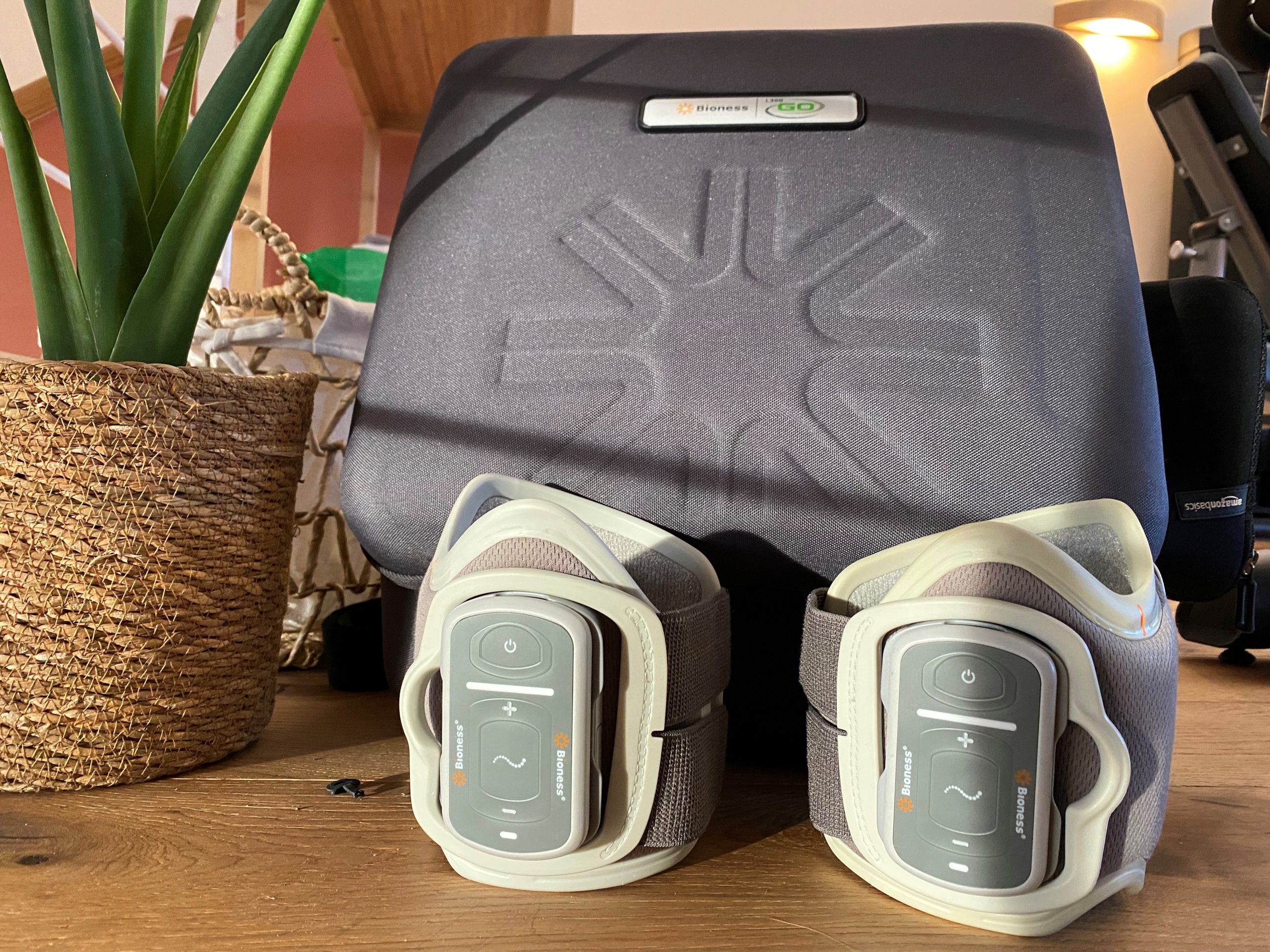 the bioness wireless FES device for left and right leg, in front of its case