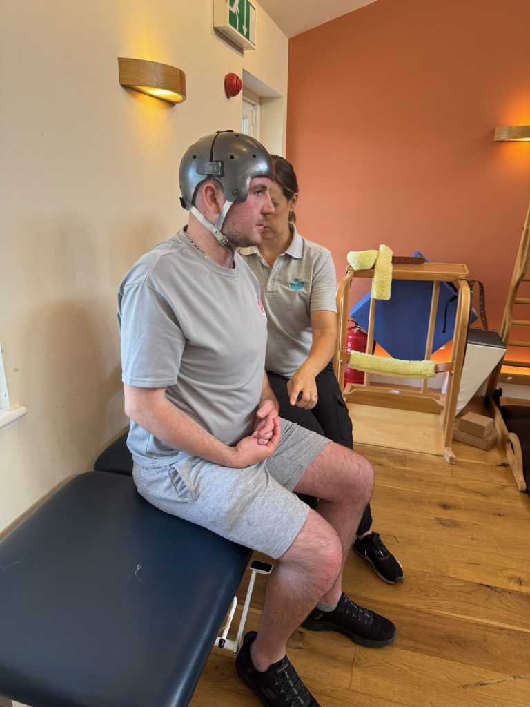 image of Oli sat on a plinth in our accessible gym