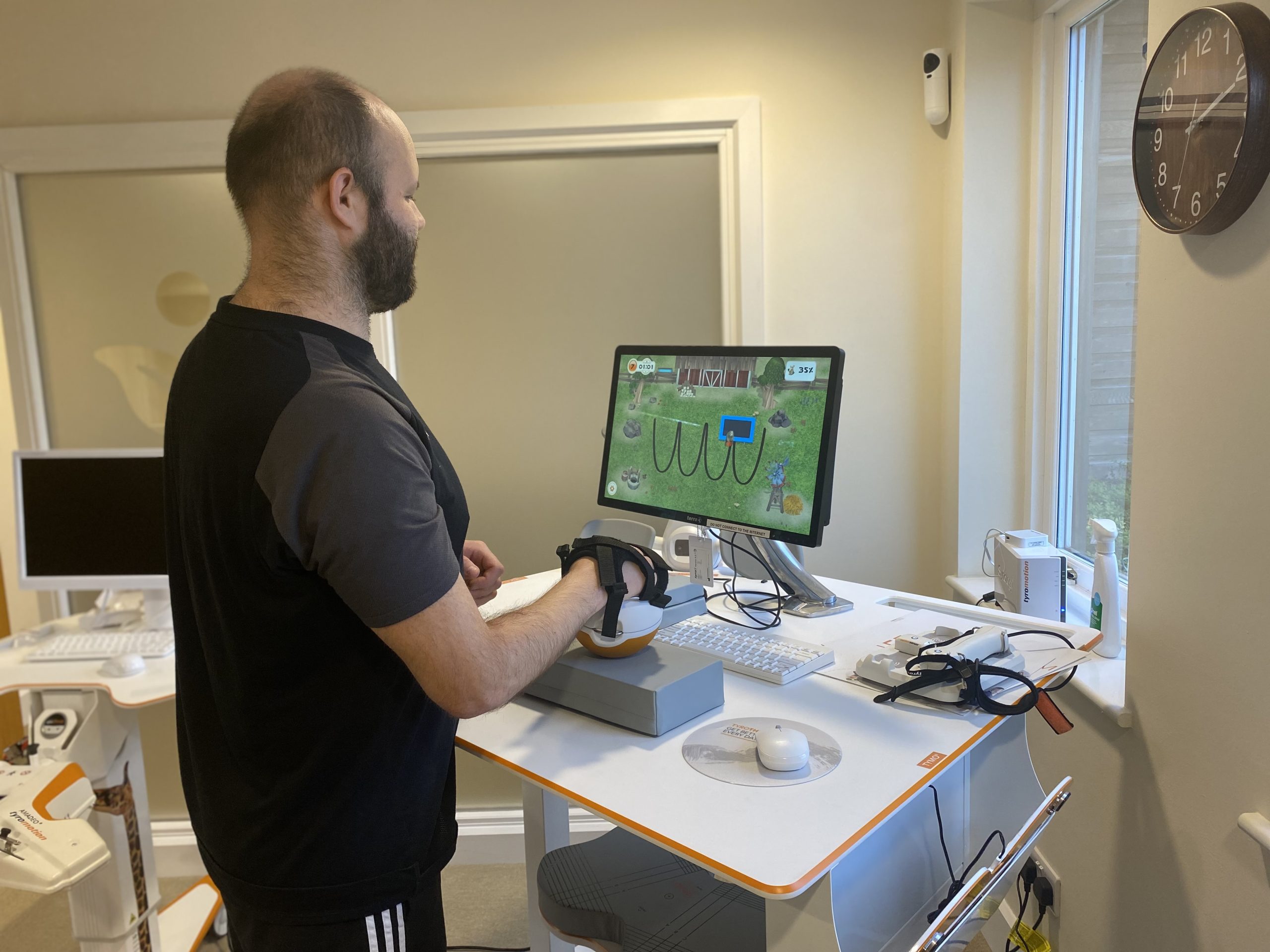tom stood using the pablo upperlimb rehab device with his left hand