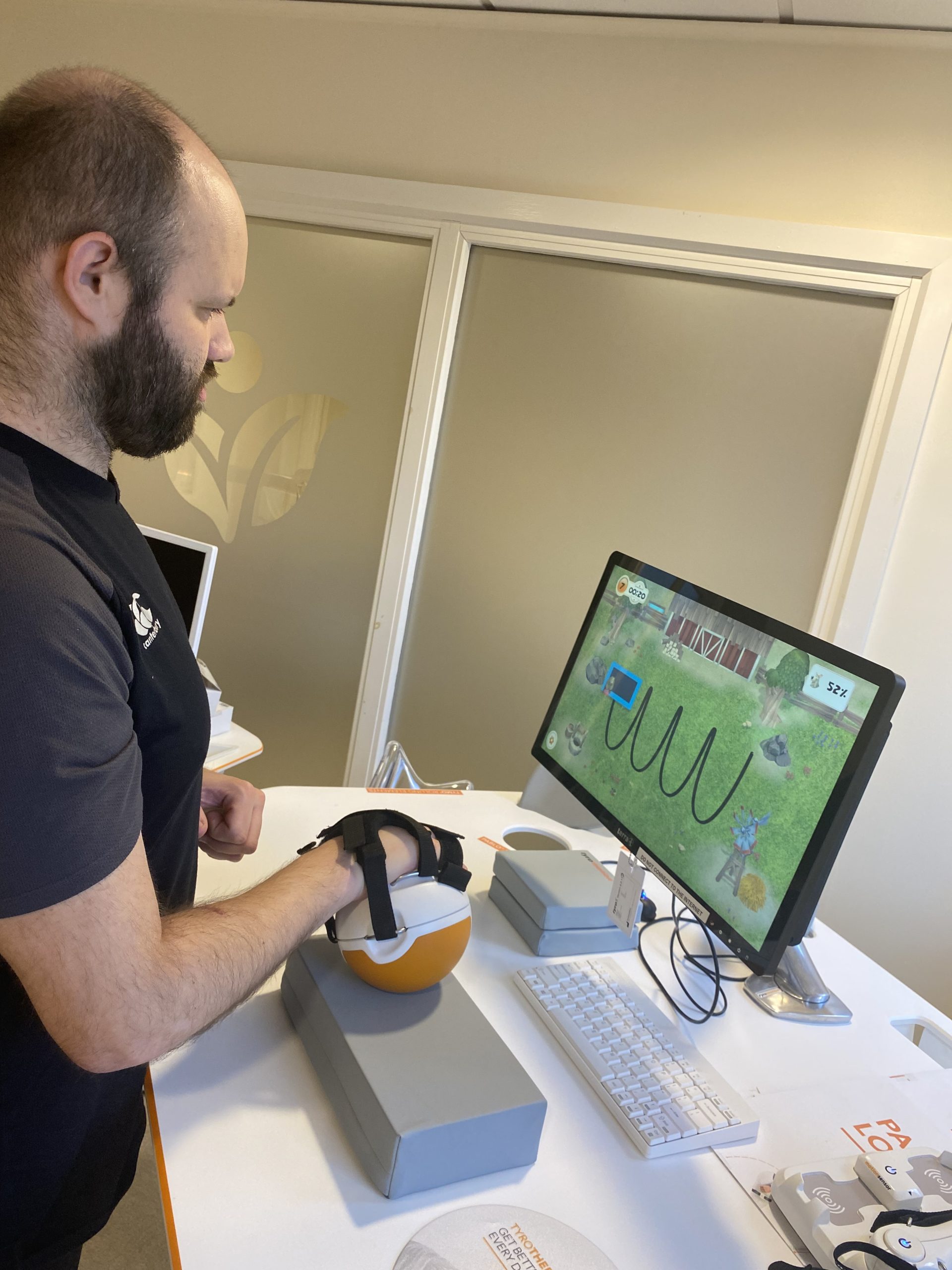 tom stood using the pablo upperlimb rehab device with his left hand