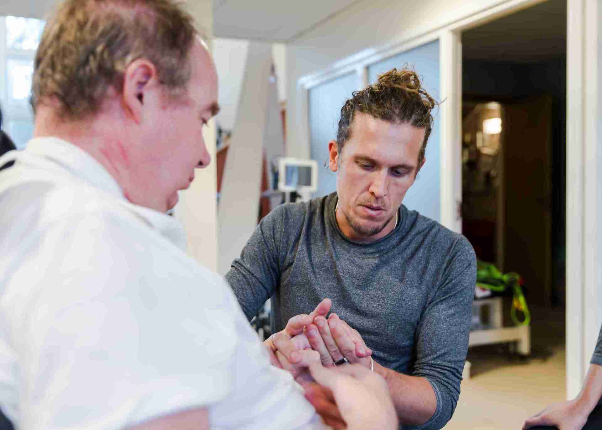 physio tom is holding Piers hand