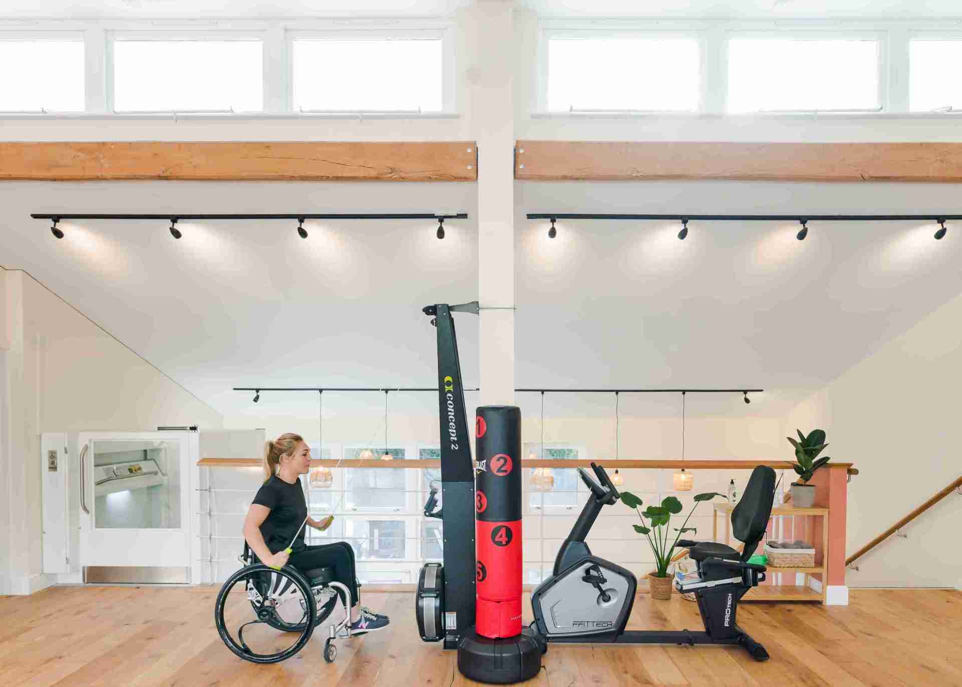 sophie morgan is sat in her wheelchair whilst using the ski erg