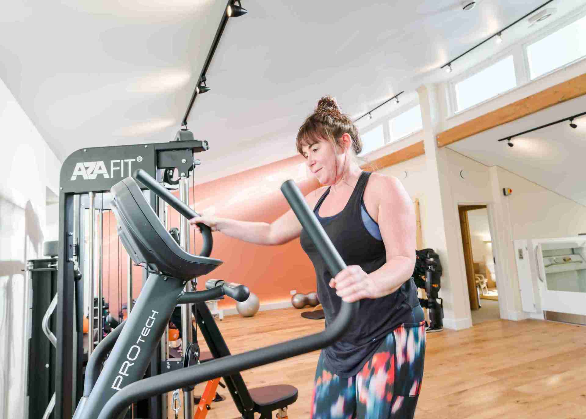 sadie stood using the cross trainer
