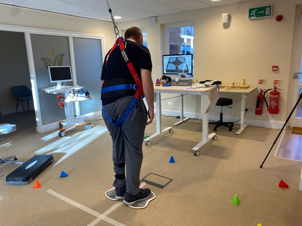 Piers is stood using balance and core rehabilitation device the Tymo