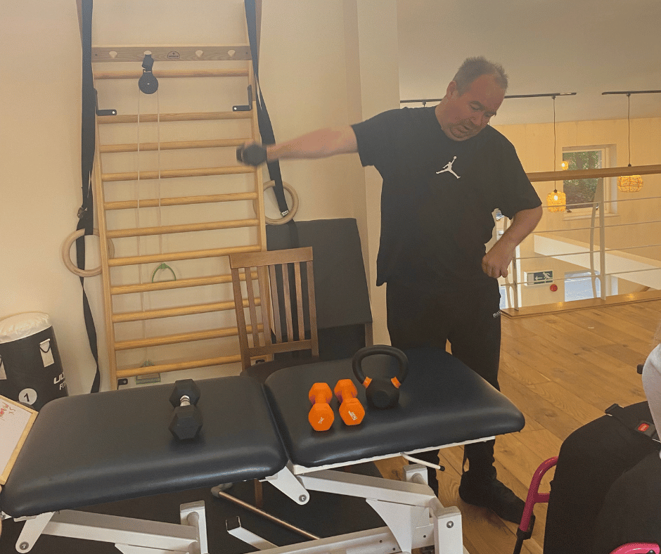 Piers stood using the free weights with his right arm