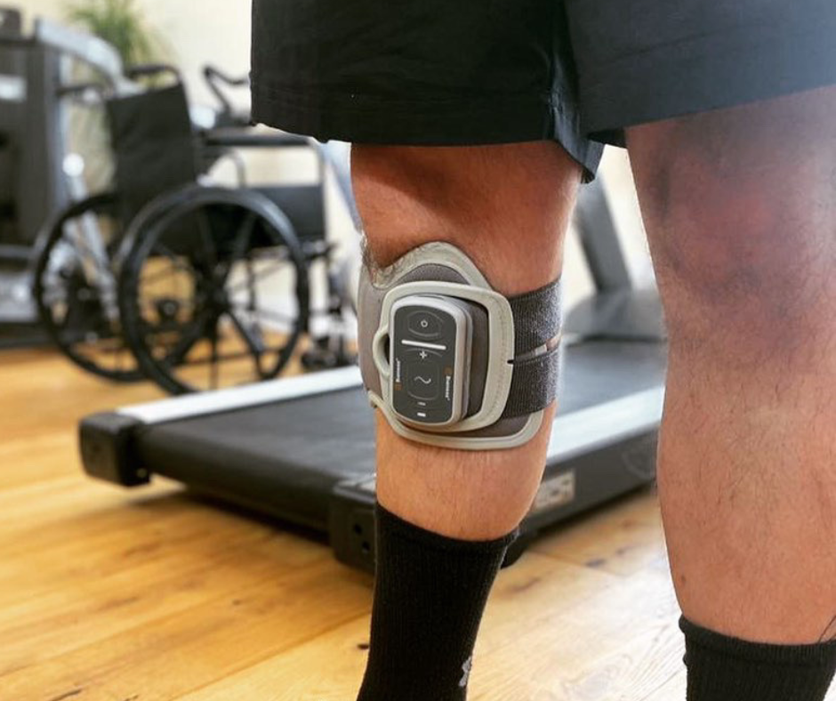 A close up of Bioness go on right leg of a man to help with foot drop.