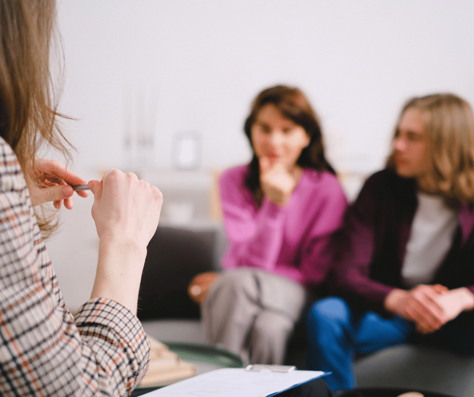 blurry image of people sat in a therapy session