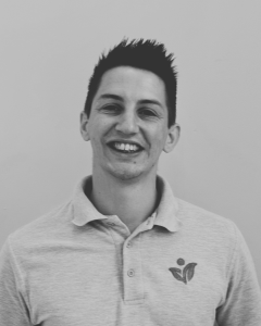 Black and white head shot of physiotherapist Kieran
