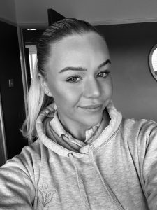 Black and white head shot of Anya in Branded Vim hoodie